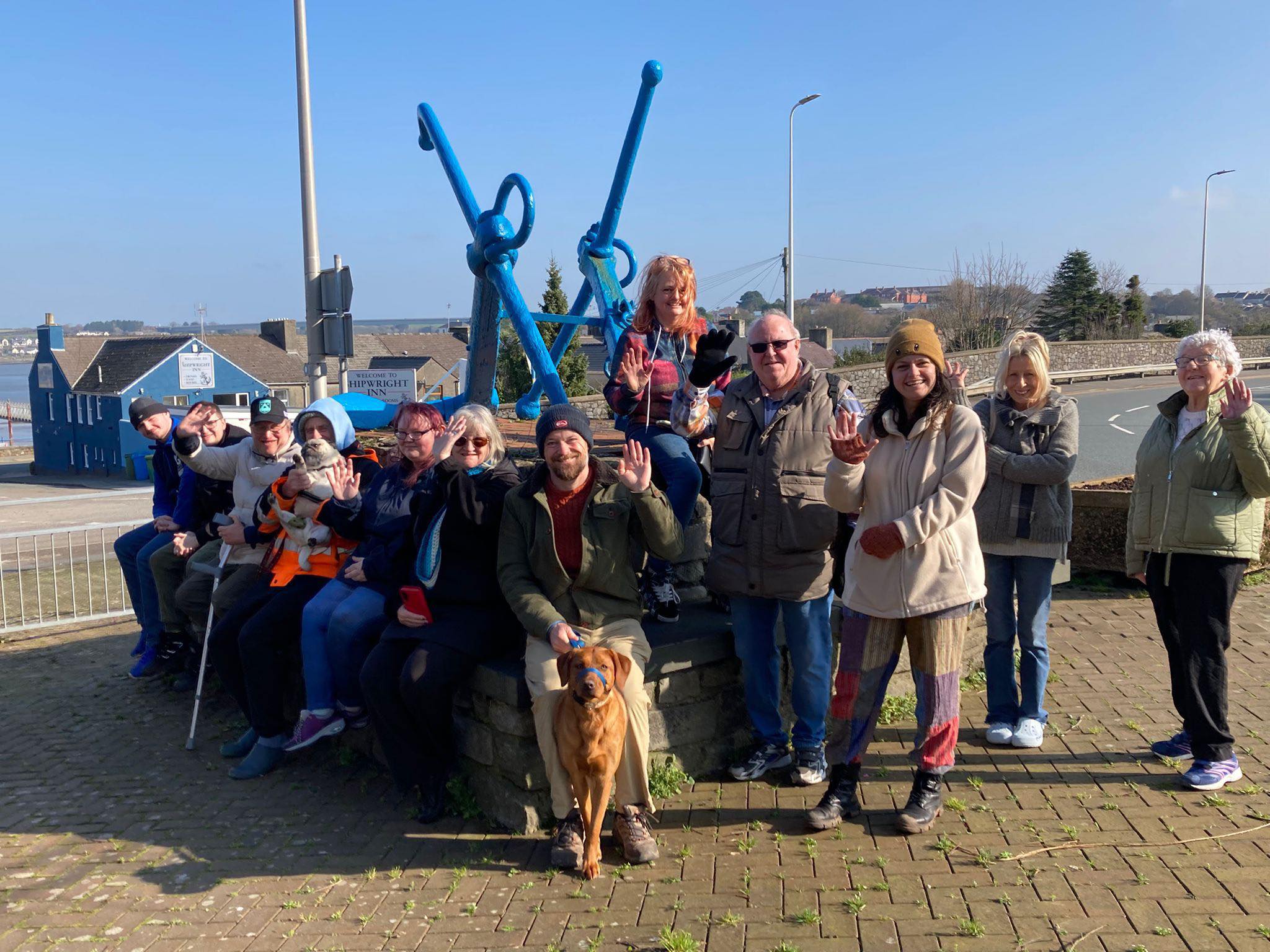 VC Wellbeing Walk group sitting by anchor in Pembroke Dock